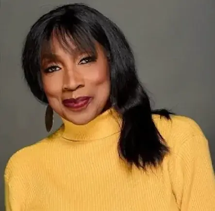 Press photo: Headshot, yellow turtleneck